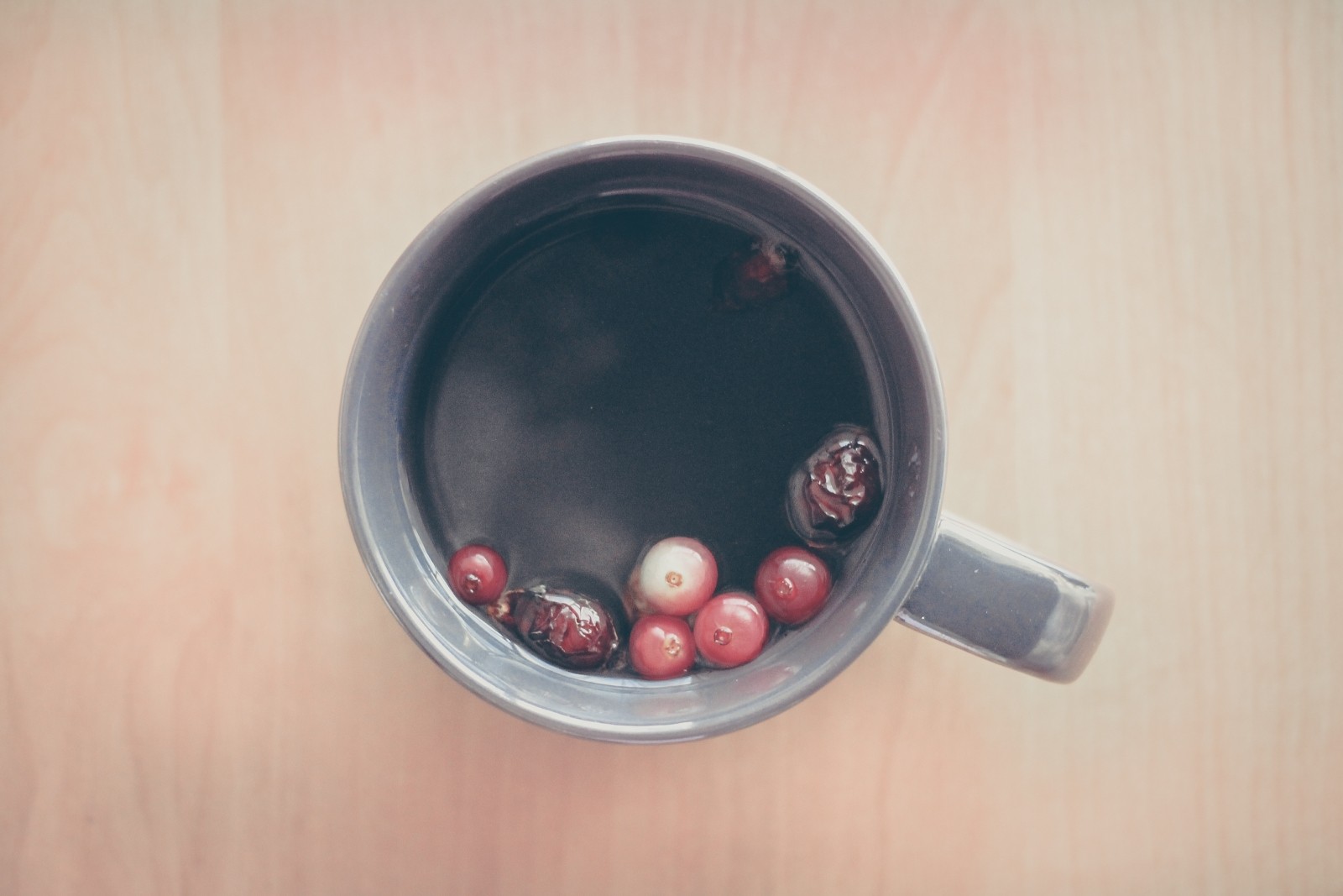 A steaming cup of our berry bliz tea with whole cranberries